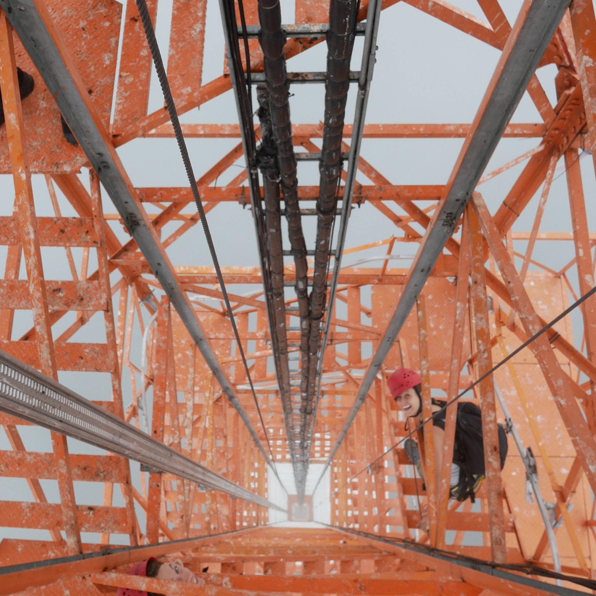Looking up at a very tall orange structure