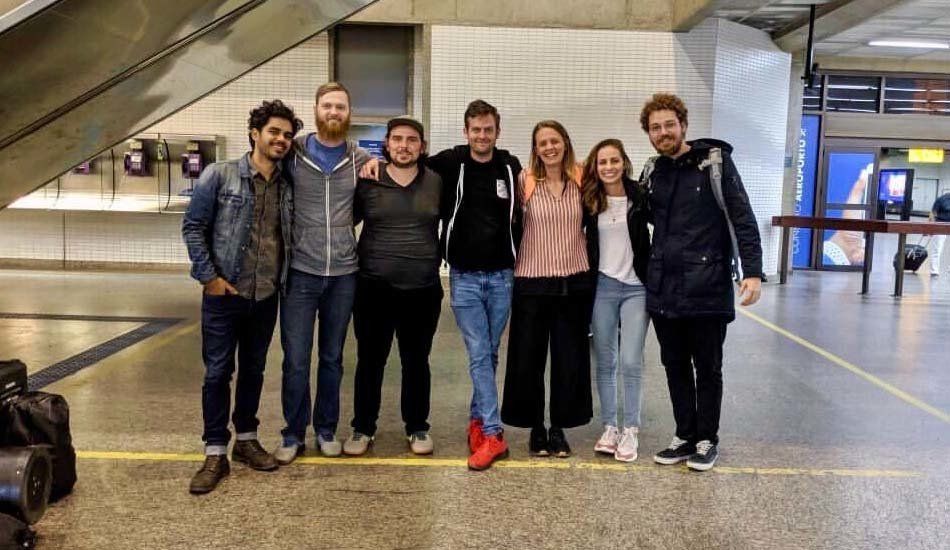A group of people are posing for a picture in an airport.