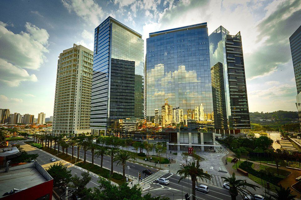 A cityscape with a lot of tall buildings and palm trees
