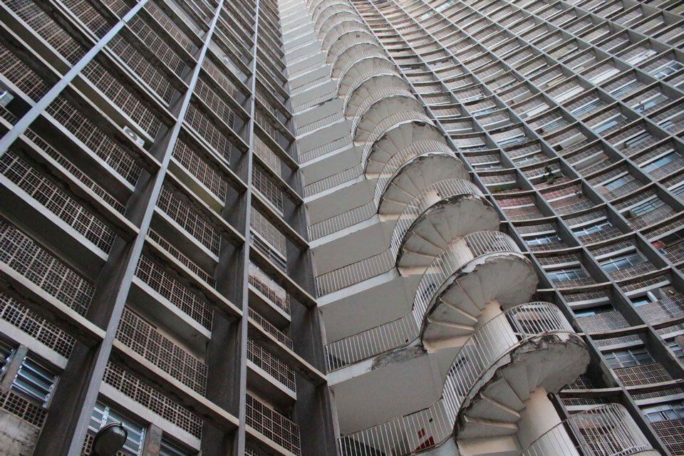 Looking up at a very tall building with spiral stairs