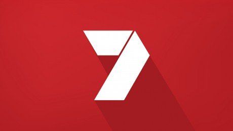 A white number 7 with a long shadow on a red background.