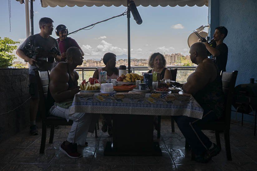 A group of people are sitting around a table with food.