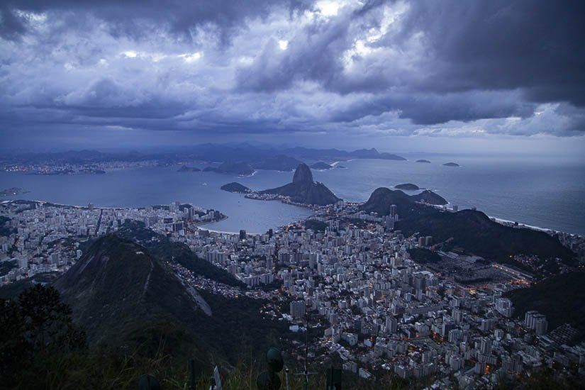 A view of a city from the top of a mountain at night.