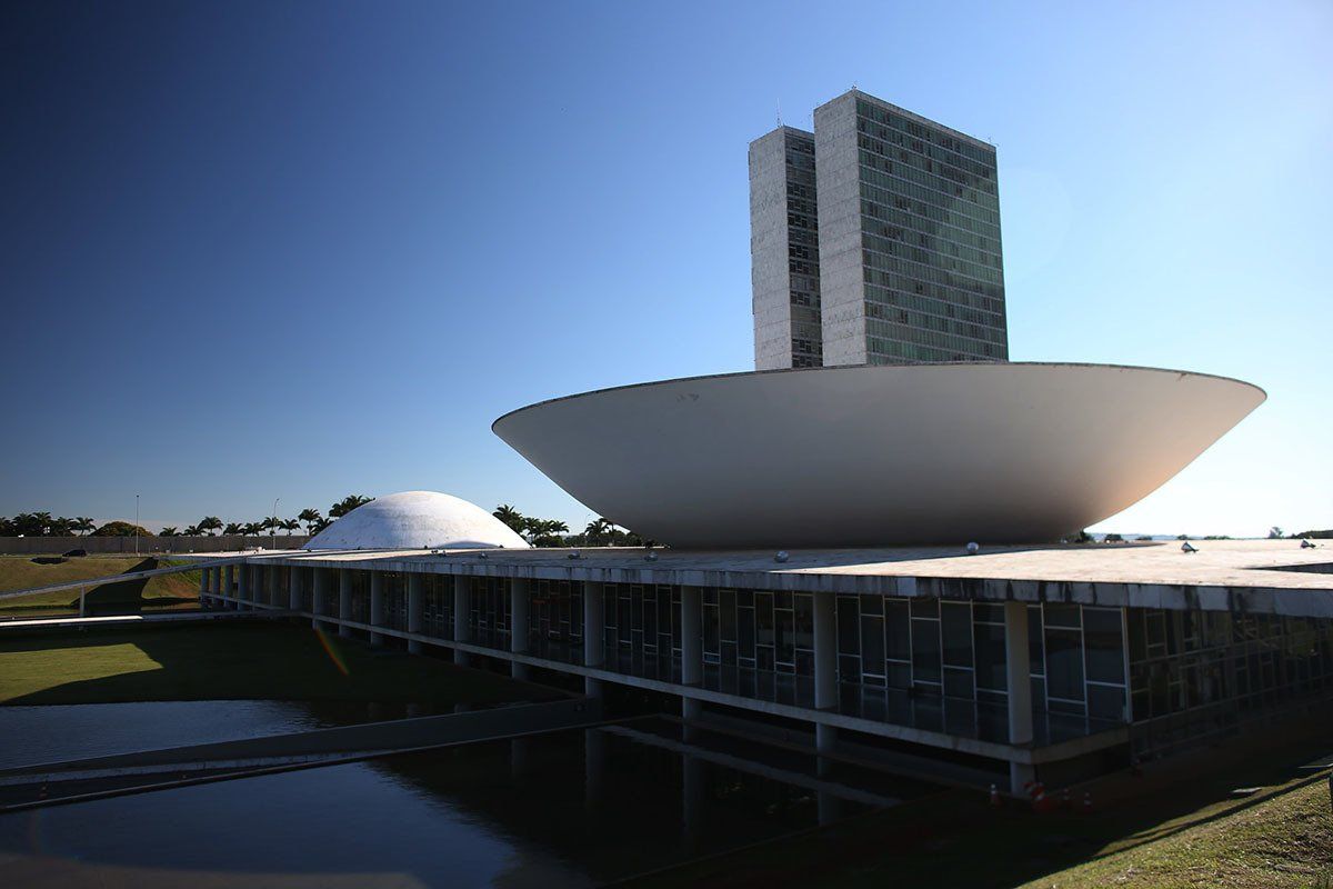 A large white building with a blue sky in the background