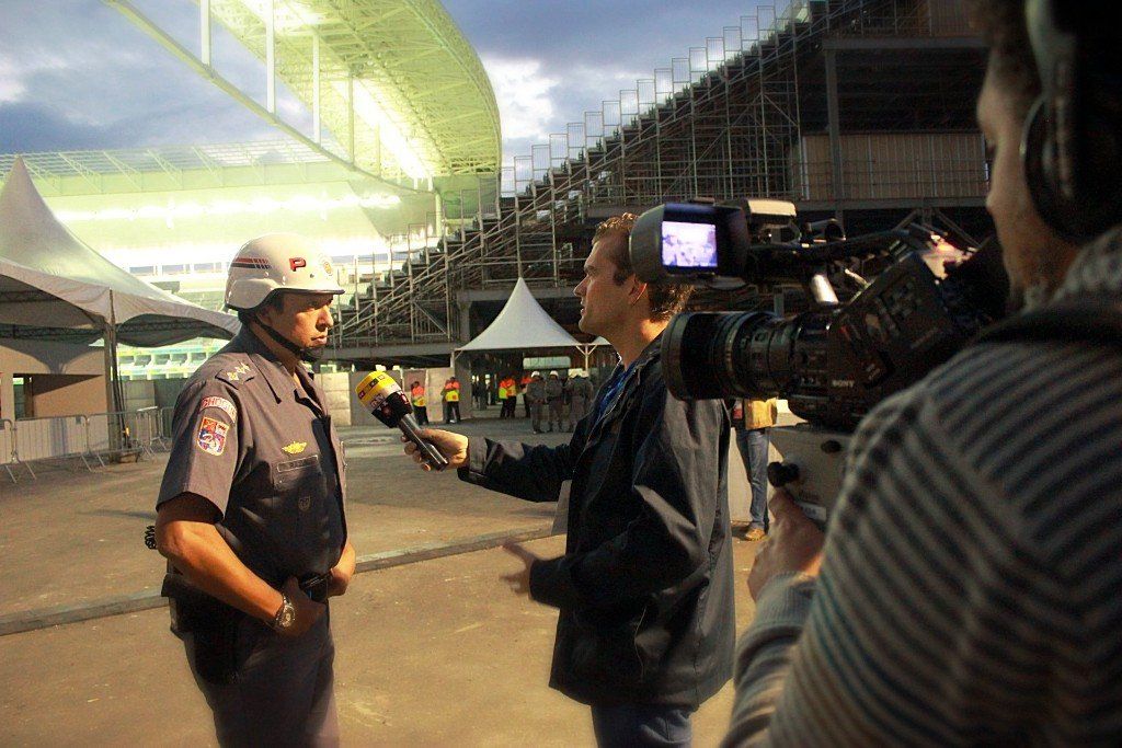 A police officer is being interviewed by a cameraman