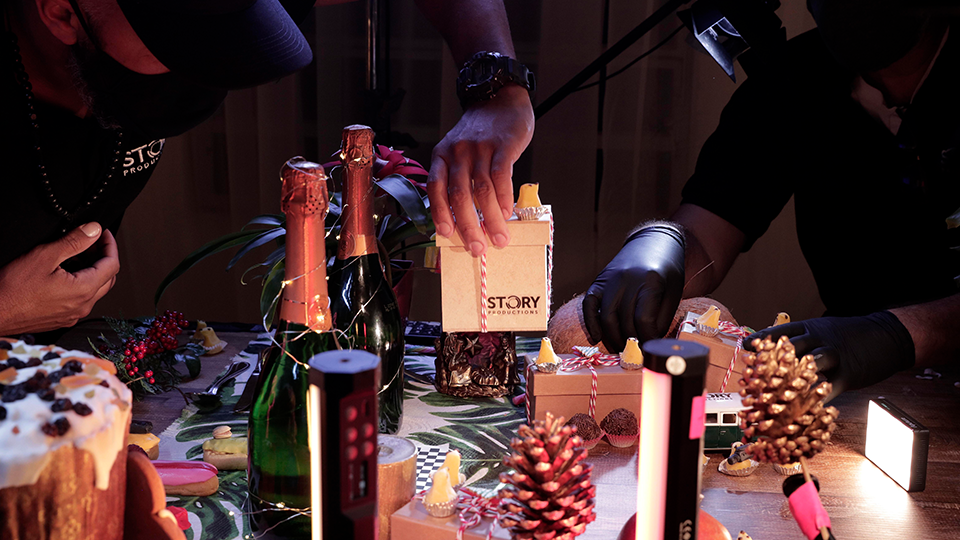A group of people are sitting at a table with bottles of champagne.