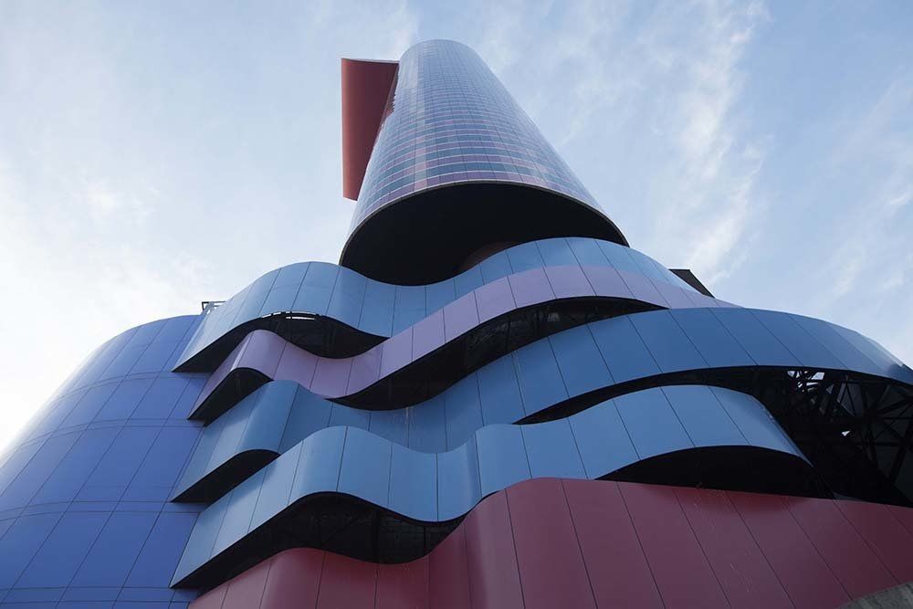 Looking up at a colorful building with a blue sky in the background