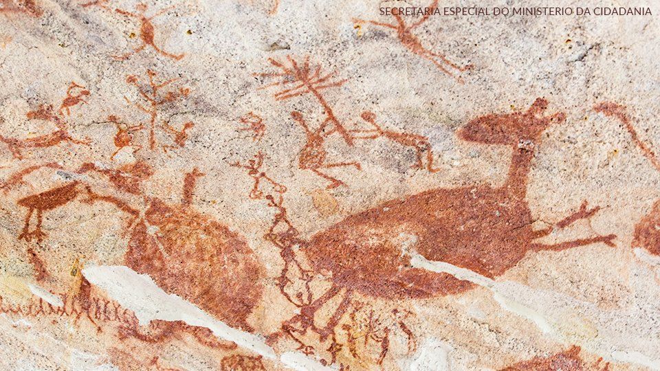 Mural paiting at Serra Capivara A close up of a painting of animals on a wall.