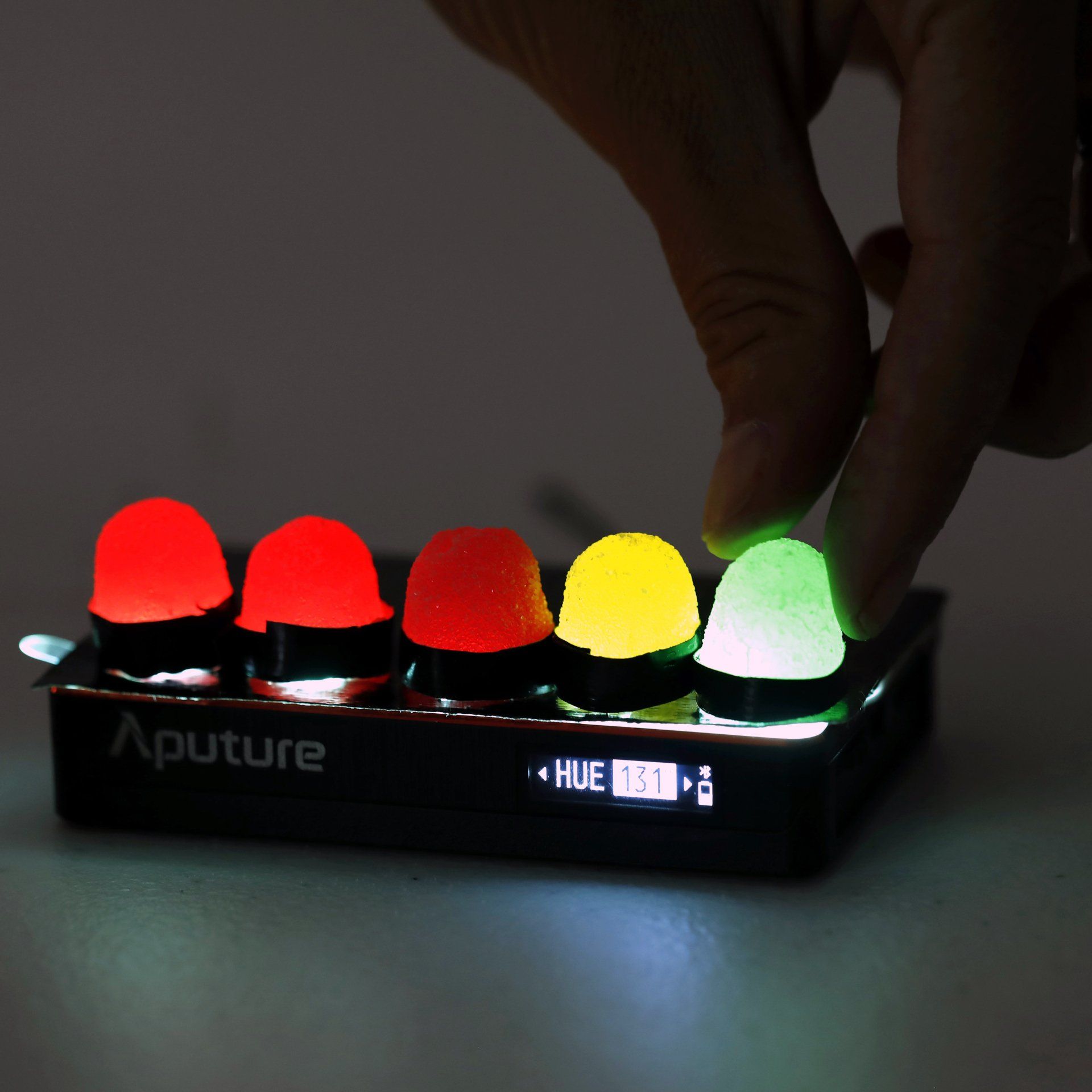 Set details A person is pressing a button on an aputure device