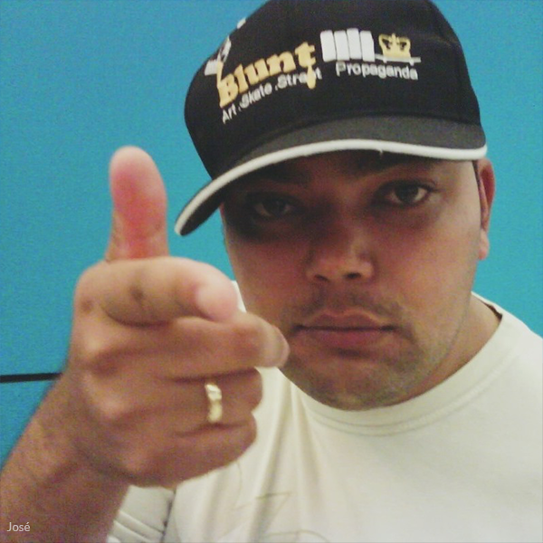 A man wearing a blunt propaganda hat gives a thumbs up
