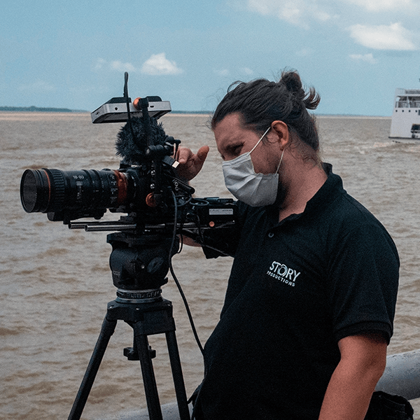 Story Productions crew films on location A man wearing a story shirt is taking a picture