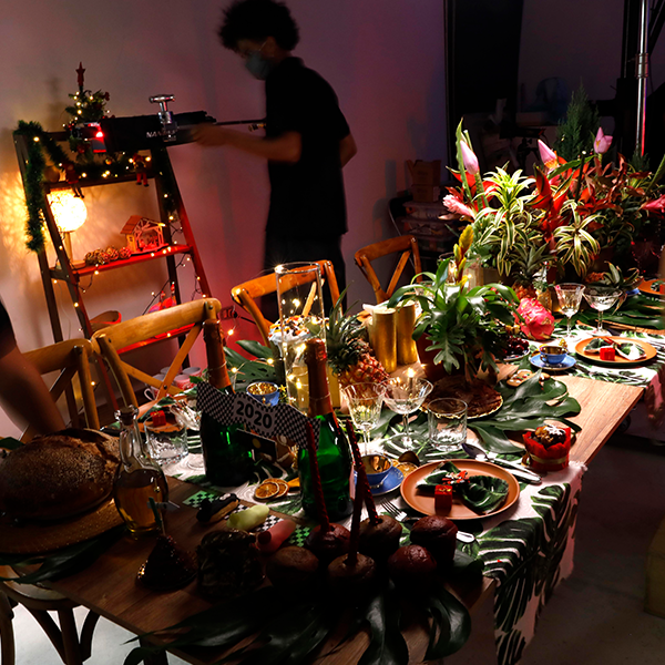 A table with a lot of food and flowers on it
