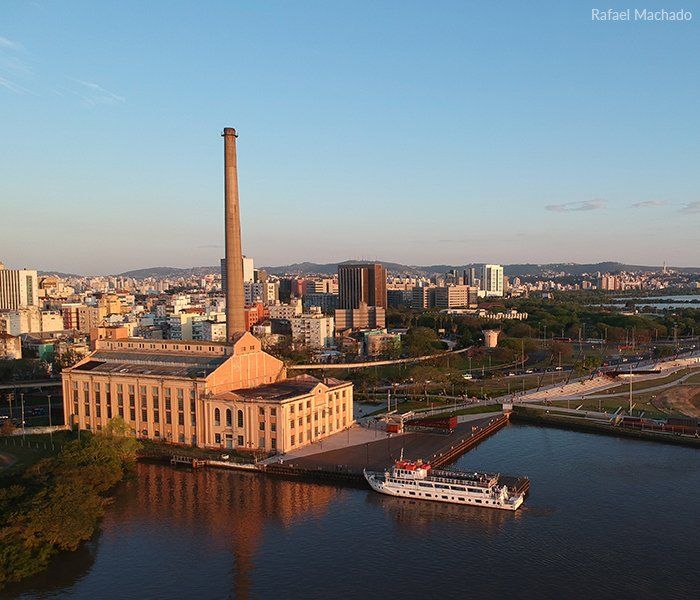 An aerial view of a city with a boat in the water