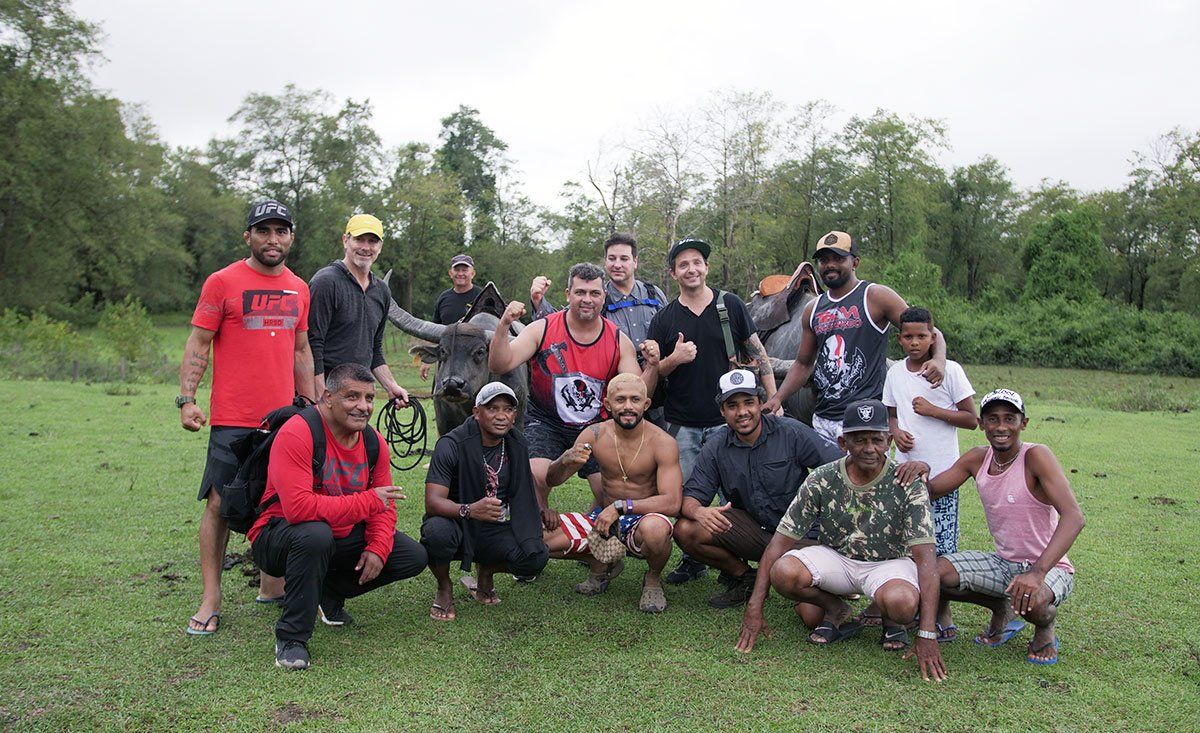 A group of men are posing for a picture in a field.