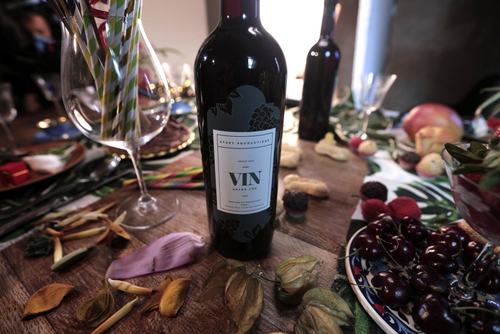 A bottle of vin wine is sitting on a table