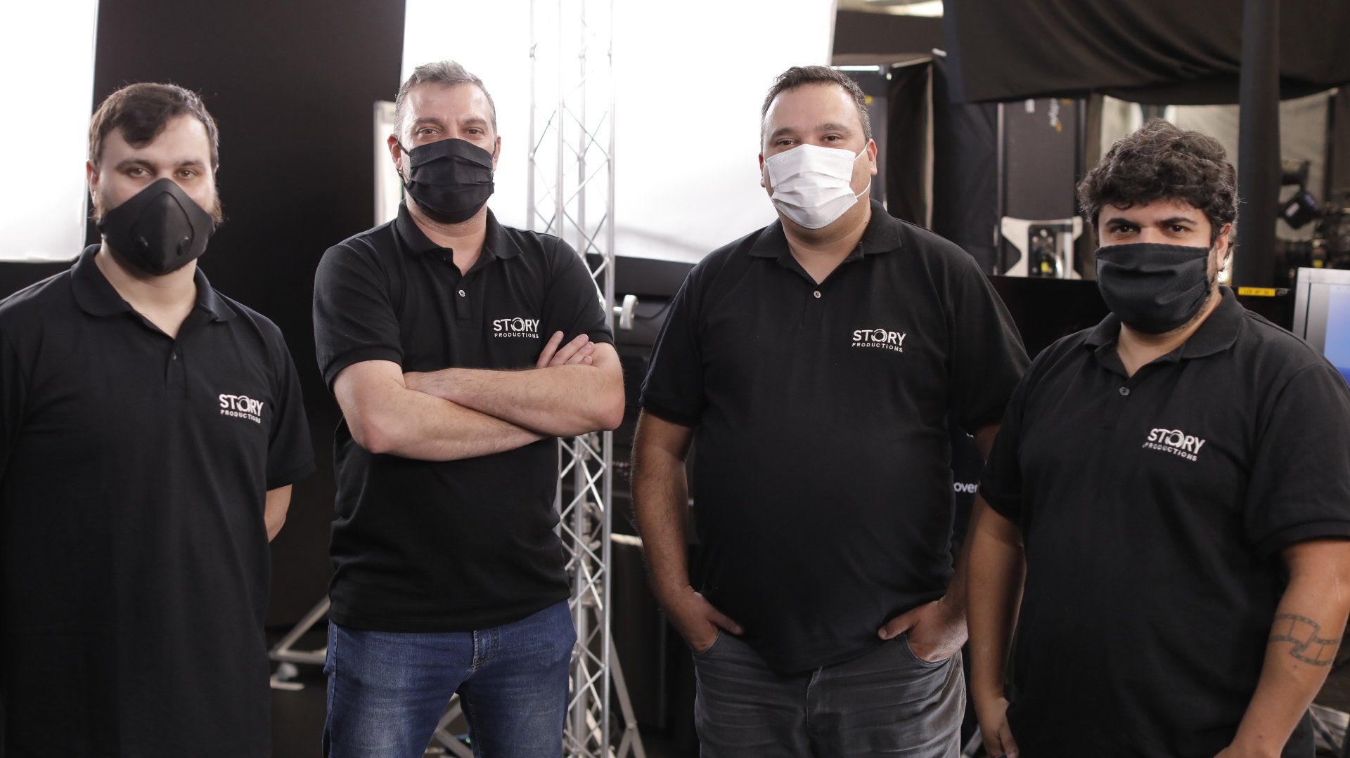 A group of men wearing face masks are standing next to each other.