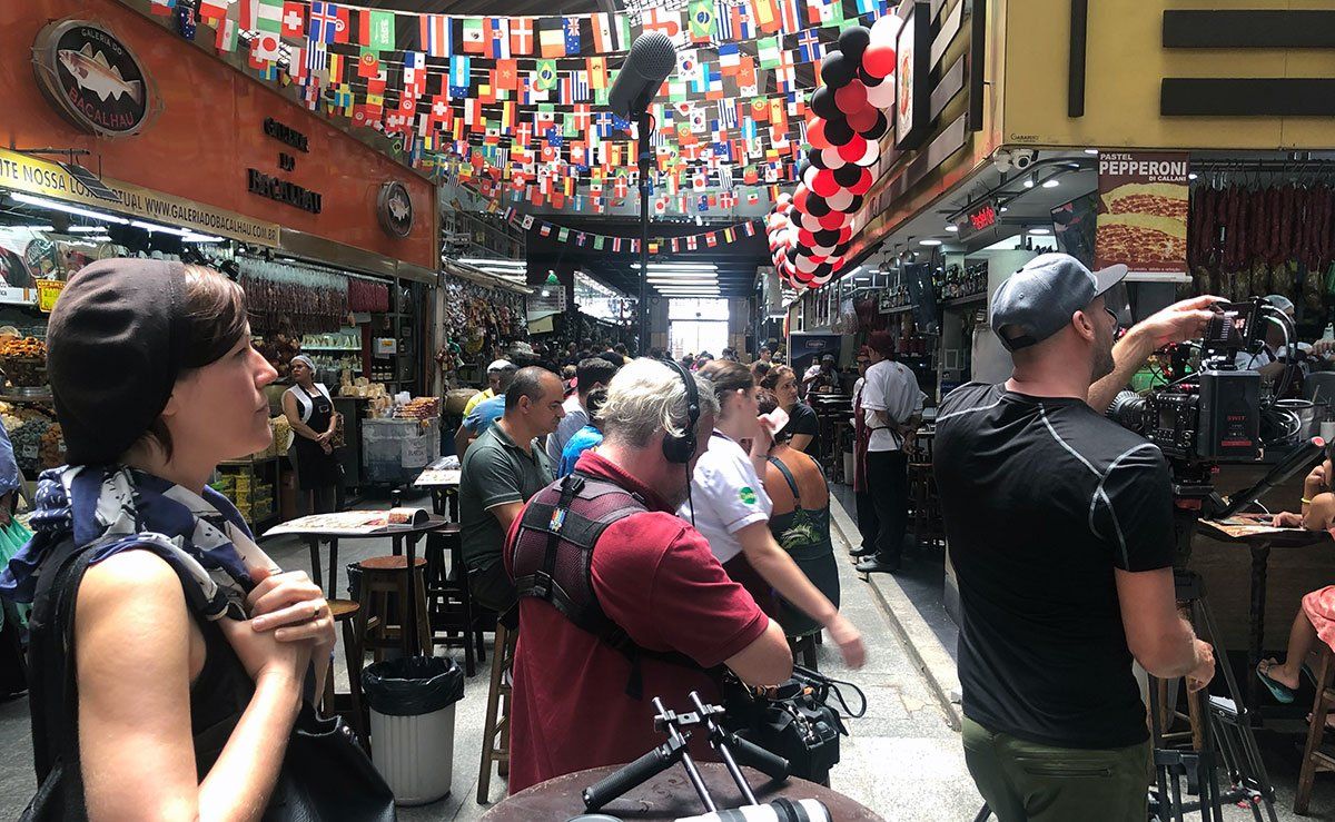 A group of people are standing in a market.