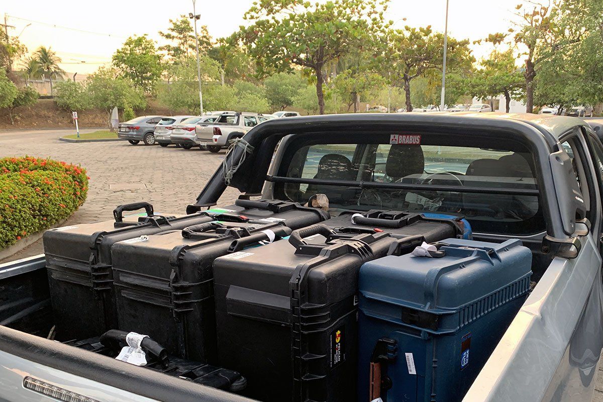 The back of a truck is filled with boxes and luggage.