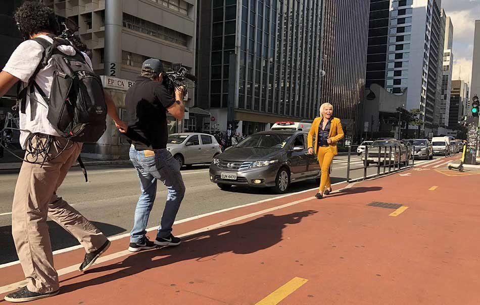 A group of people are walking down a street in a city.