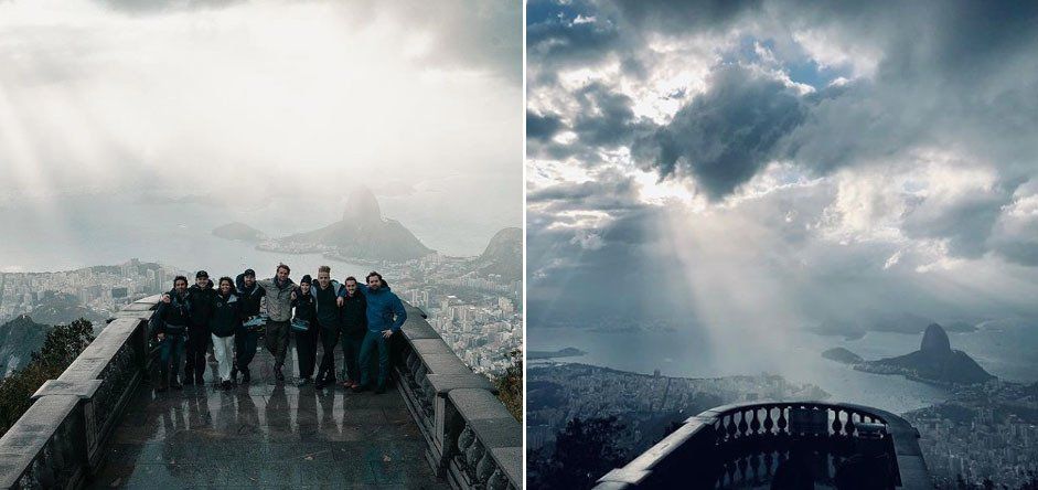 A group of people are standing on top of a mountain.