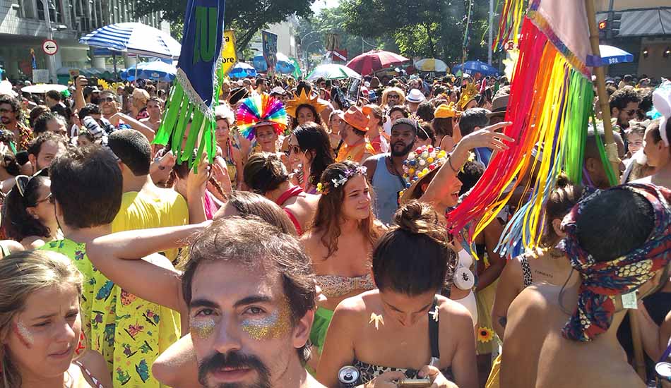 A man is taking a picture of a crowd of people at a carnival.