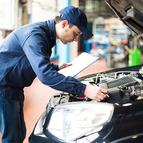 Mechanic Working On Car Engine — Denver, CO — AC Transmission Center Mechanic Working On Car Engine — Denver, CO — AC Transmission Center