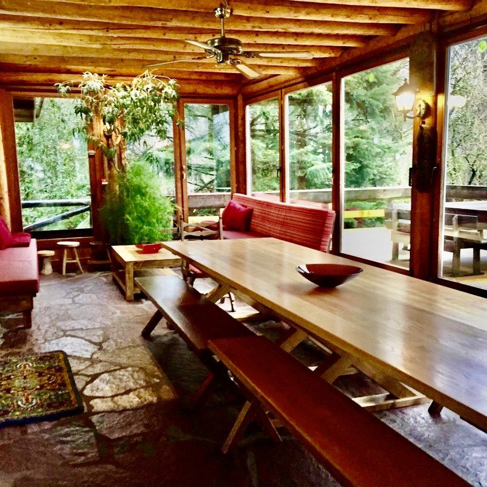 Een kamer met een lange houten tafel en banken
