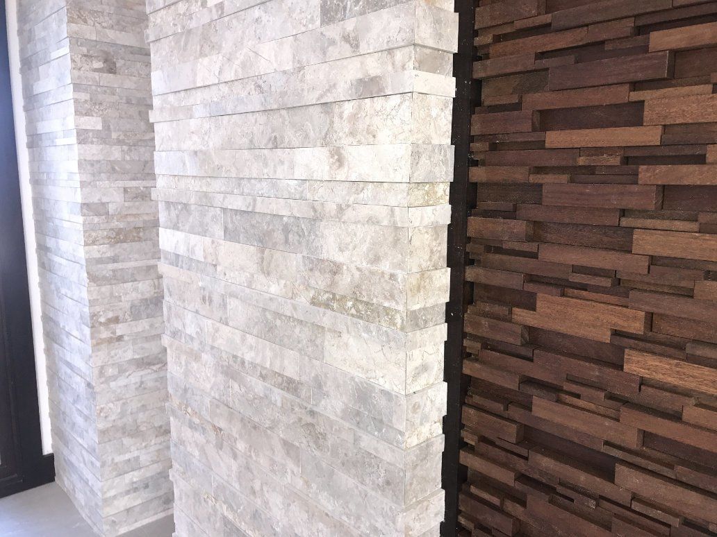 a hallway with a stone wall and a wooden wall tiled.
