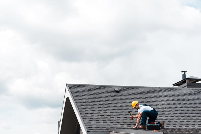 Man Repairing Residential Roof — Madison, WI — Craftsman Exteriors Man Repairing Residential Roof — Madison, WI — Craftsman Exteriors