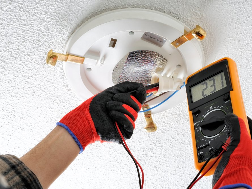 Electrician technician measures the voltage — R & M Electrical in Townsville, QLD