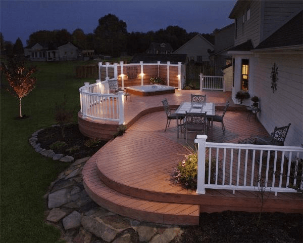 A large deck with a table and chairs on it