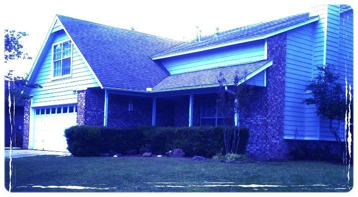 Abba Homes blue house with a white garage door and a porch