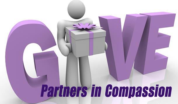 A person holding a gift in front of the word give partners in compassion