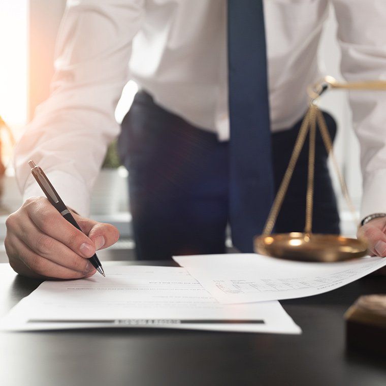 Lawyer Signing Papers — Roxboro, NC — Grissom & Holloman, PC