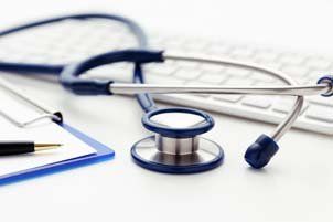 Stethoscope Sitting Atop Keyboard and Clipboard