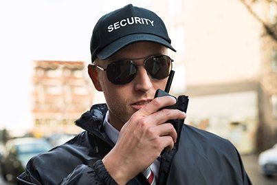 Officer Using Walkie Talkie - Patrol Service in Bismarck, ND