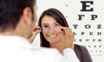 Doctor giving eye exam to a woman in Greensburg, IN Doctor giving eye exam to a woman in Greensburg, IN