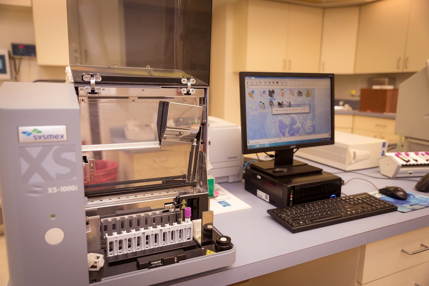 a computer is sitting on a desk next to a medical device