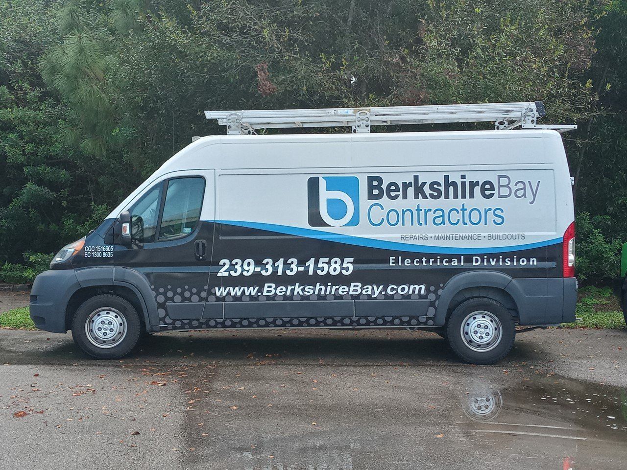 Hand of an electrician with multimeter probe — Fort Myers, FL — Berkshire Bay Contractors Inc.
