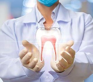 Oral Care — Dentist Holding Tooth Model in Brownsburg, IN