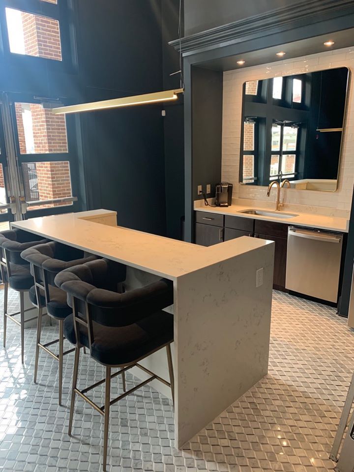A kitchen with a long table and chairs and a sink.