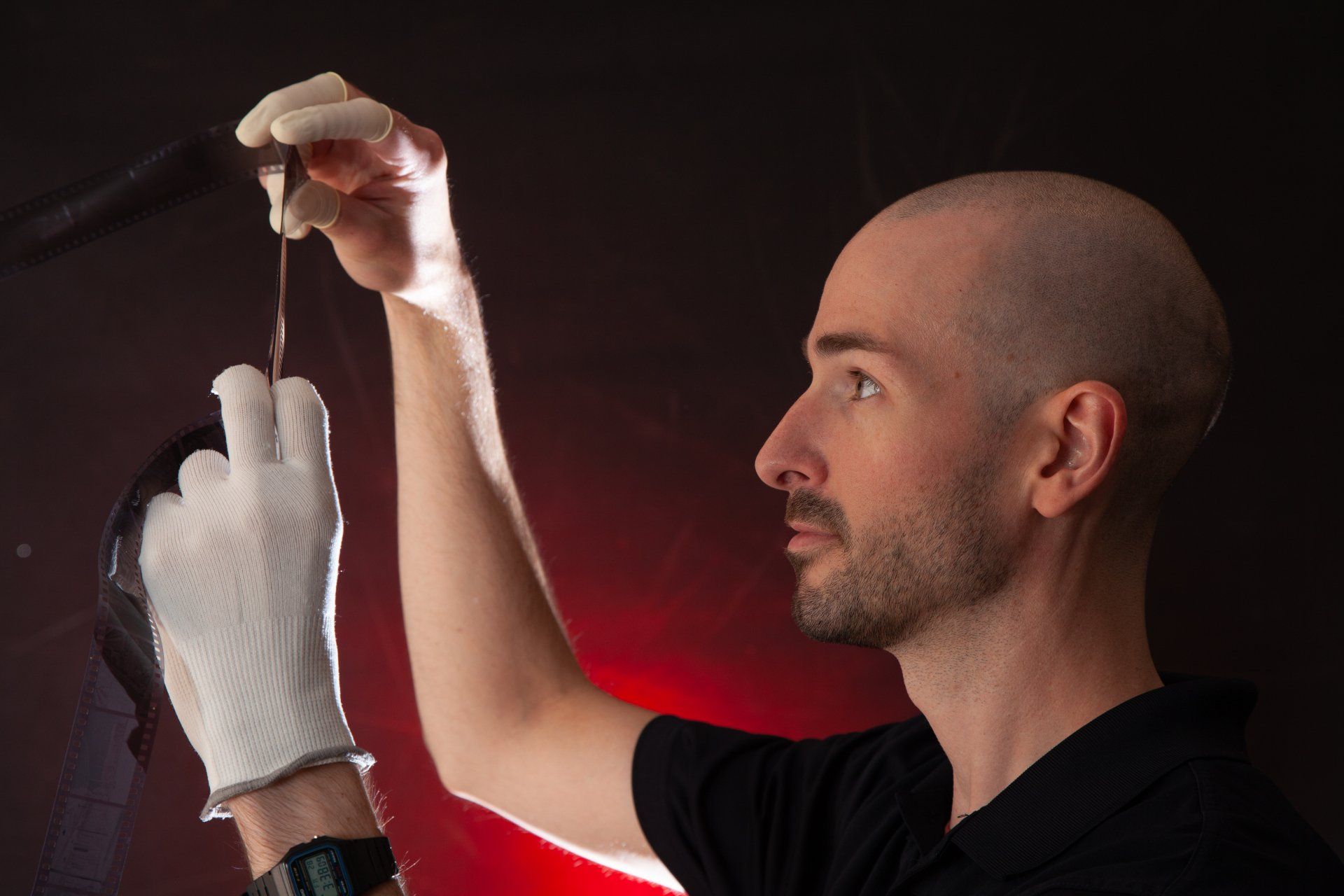 Man holding a strip of 35mm film