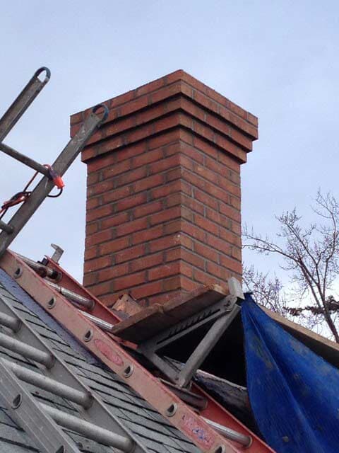 Chimney with Ladders on the Roof – West Springfield, MA – Rolandini Brothers Masonry