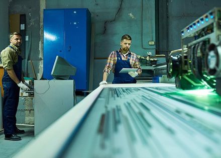 Door Company — Workers Operating Laser Engraving Unit at Factory In Pompano Beach, FL