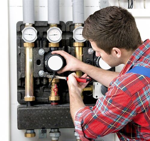 Technician servicing heating boiler in Brookville, OH