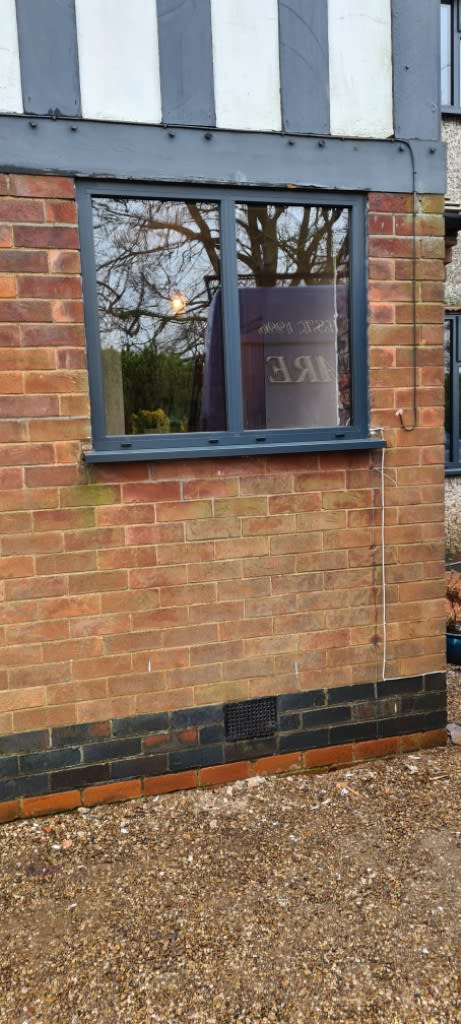 Black window drame fitted into house