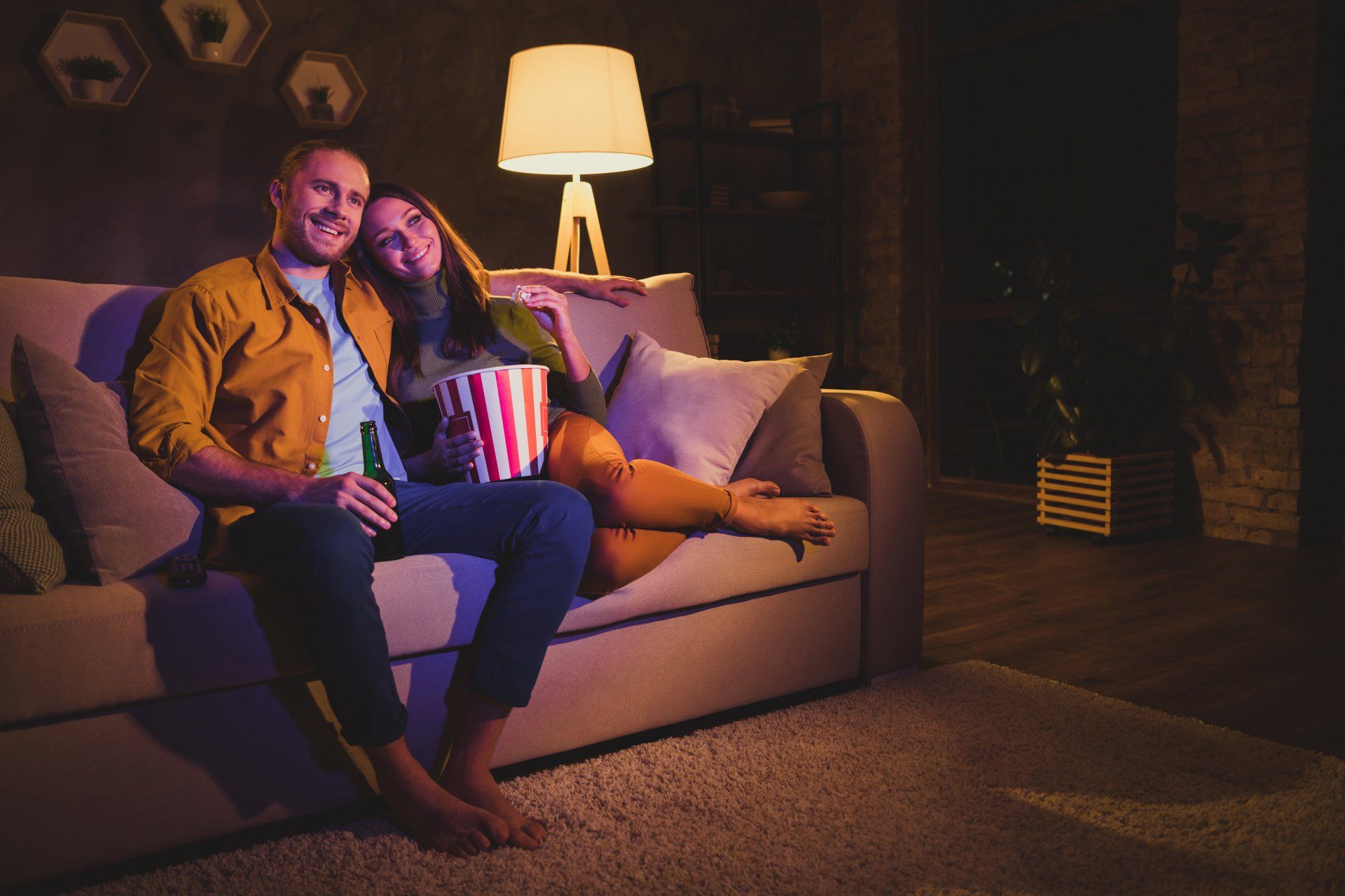 Couple on a sofa watching TV