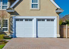 beige house with white garage door