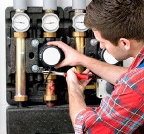 Technician Servicing Heating Boiler — Heating Services in East Providence, RI Technician Servicing Heating Boiler — Heating Services in East Providence, RI