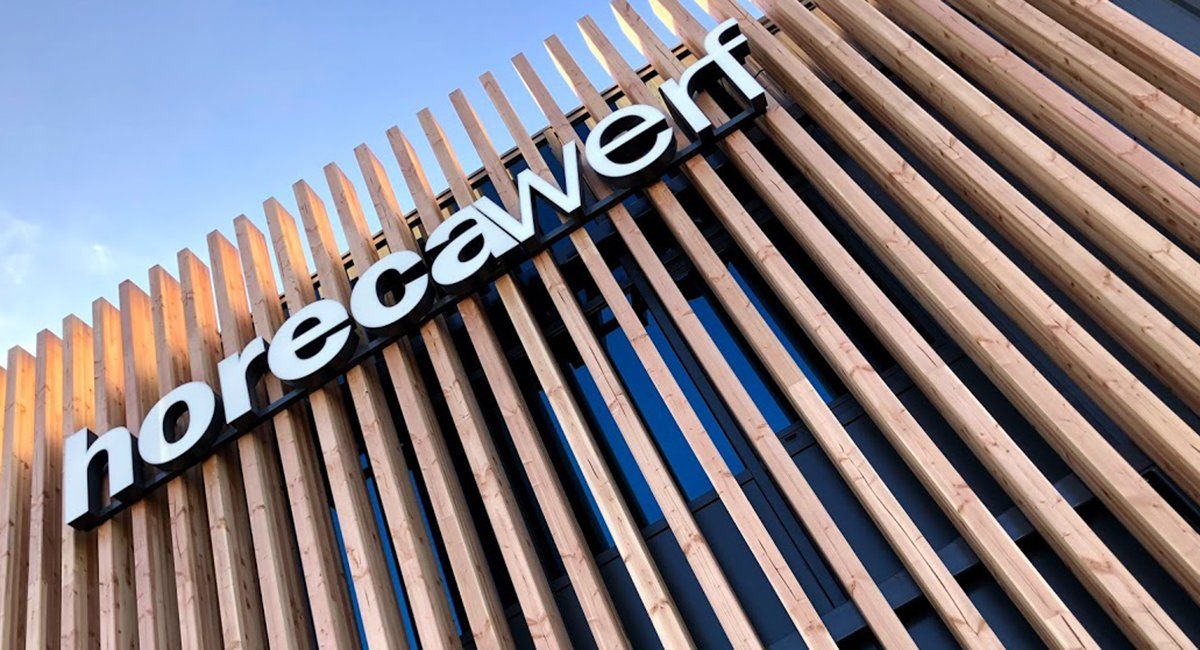 Horecawerf white logo 3D lettering sign mounted onto timber slat exterior